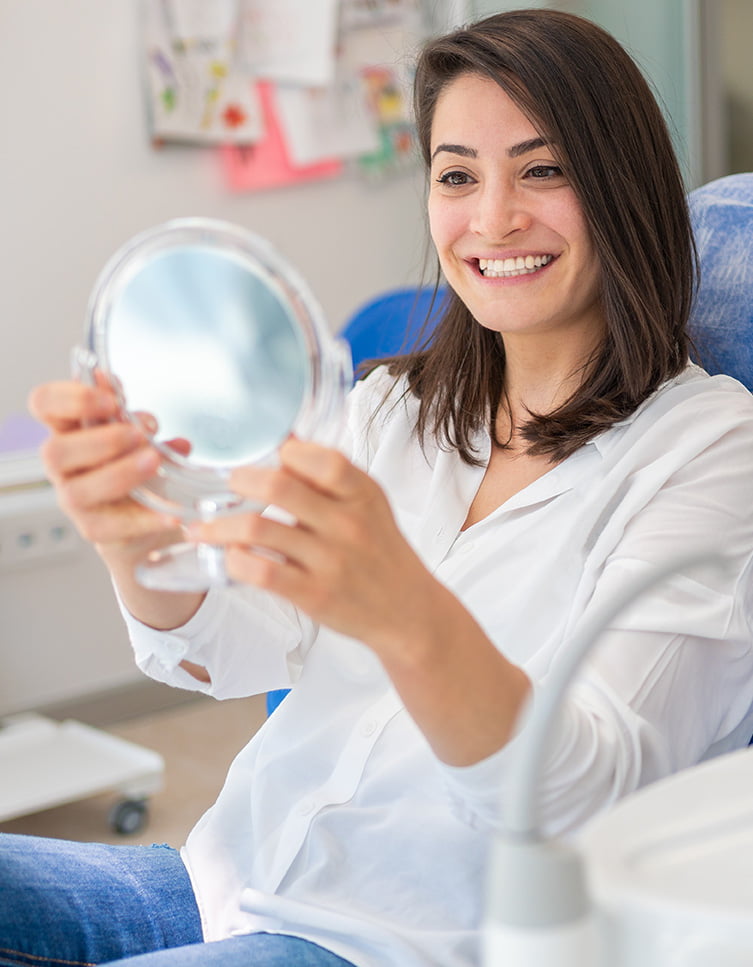 woman looking at her teeth